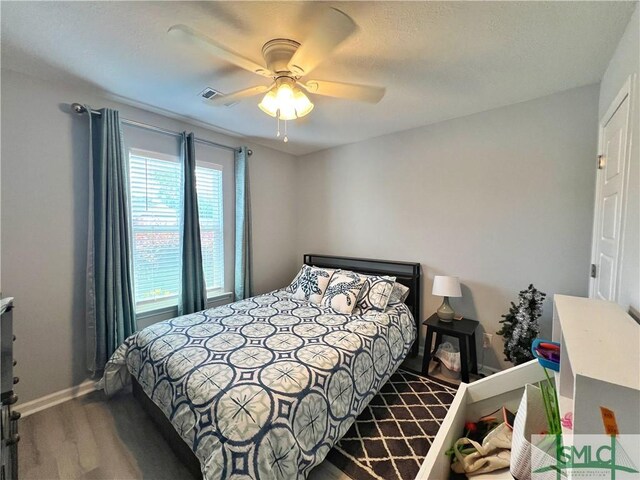 111 Auburn Cir, Glennville, GA 30427 - bedroom featuring wood finished floors, baseboards, and a ceiling fan