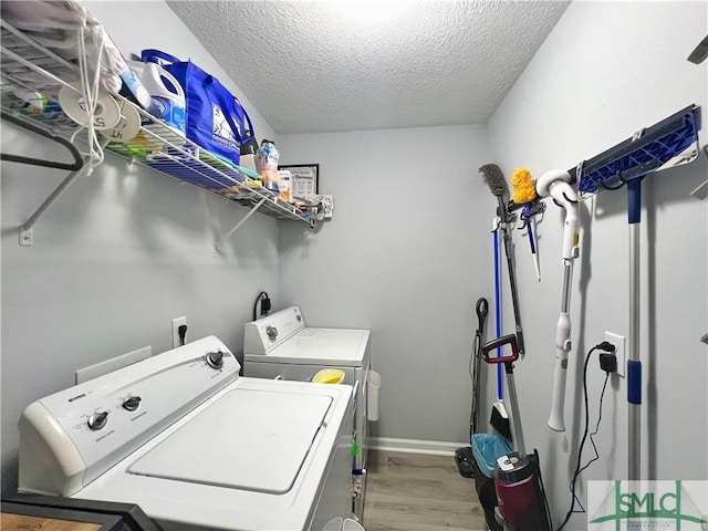 111 Auburn Cir, Glennville, GA 30427 - laundry room featuring washing machine and dryer, wood finished floors, a textured ceiling, and baseboards
