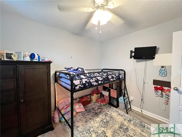 111 Auburn Cir, Glennville, GA 30427 - bedroom with light wood-style floors, baseboards, ceiling fan, and a textured ceiling