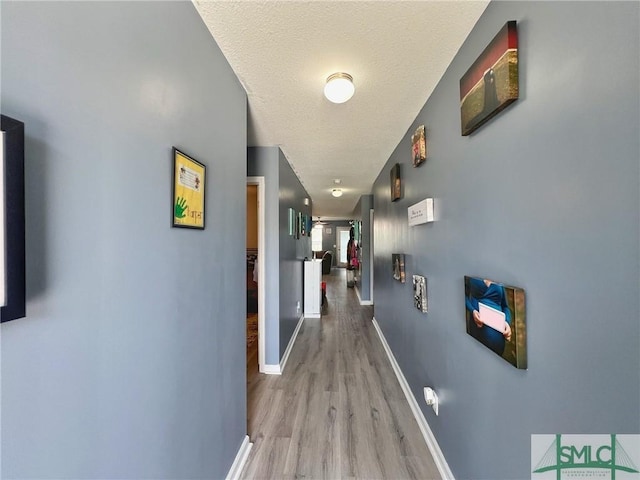 111 Auburn Cir, Glennville, GA 30427 - hallway with wood finished floors, baseboards, and a textured ceiling
