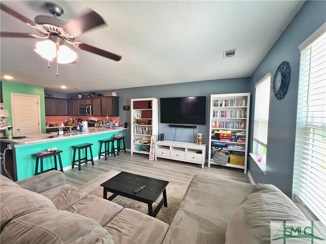 111 Auburn Cir, Glennville, GA 30427 - living area with ceiling fan, light wood-style flooring, and a textured ceiling