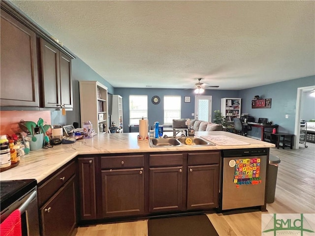 111 Auburn Cir, Glennville, GA 30427 - kitchen with appliances with stainless steel finishes, a sink, open floor plan, light countertops, and light wood-style floors