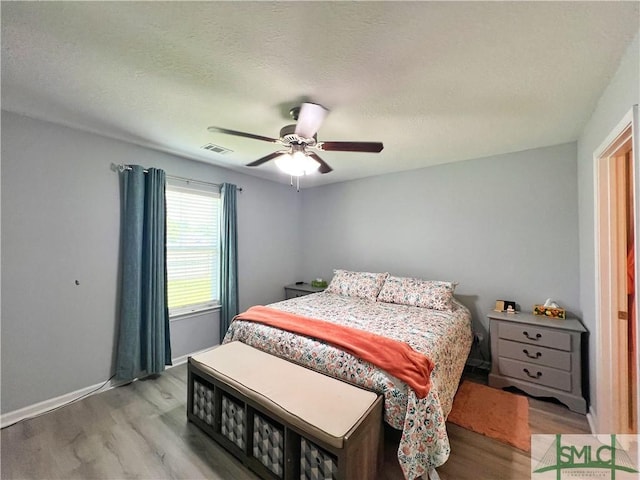 111 Auburn Cir, Glennville, GA 30427 - bedroom with light wood finished floors, a ceiling fan, and baseboards