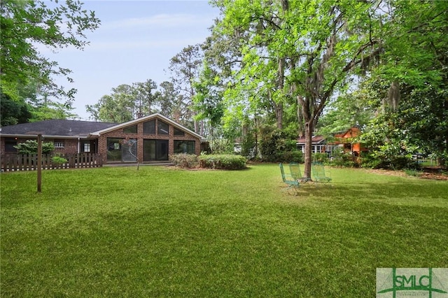 rear view of house featuring a lawn