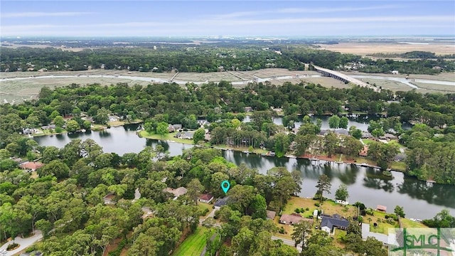aerial view of property and surrounding area with a large body of water and a tree filled landscape