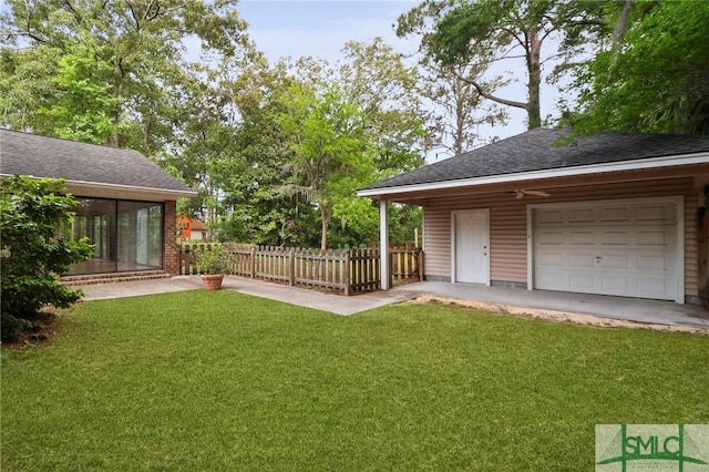 view of yard with a garage and a sunroom