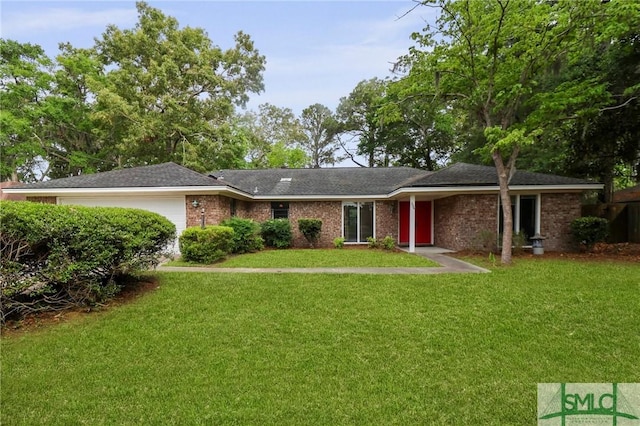 view of front of property featuring a garage and a front yard