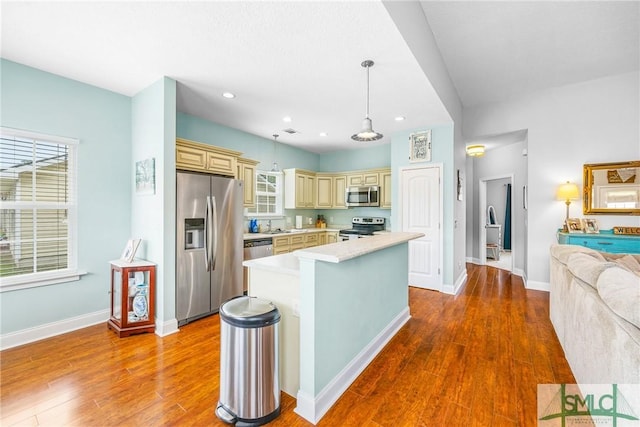 107 Christian Ct, Rincon, GA 31326 - kitchen with cream cabinetry, appliances with stainless steel finishes, wood finished floors, light countertops, and recessed lighting