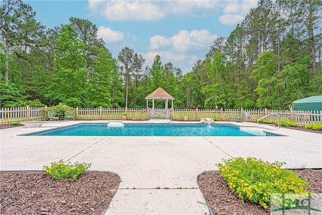 view of swimming pool featuring a patio area, a fenced backyard, and a gazebo