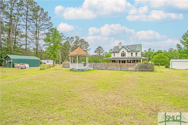 view of yard with a gazebo, an outdoor structure, and a carport