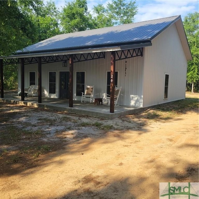 26 Cason Dr, Pembroke, GA 31321 - rear view of house featuring a patio area and metal roof
