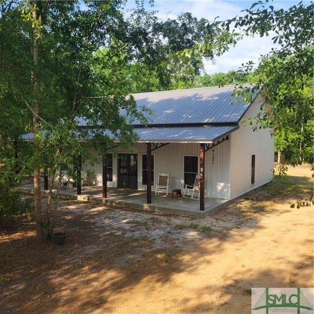 26 Cason Dr, Pembroke, GA 31321 - back of property with a patio area and metal roof