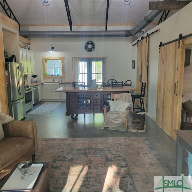 26 Cason Dr, Pembroke, GA 31321 - basement featuring freestanding refrigerator, a barn door, and a sink