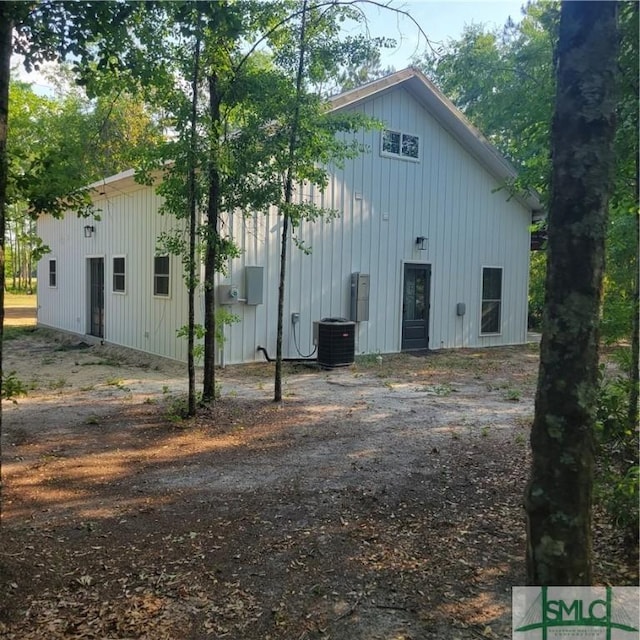 26 Cason Dr, Pembroke, GA 31321 - view of side of property with board and batten siding and central AC