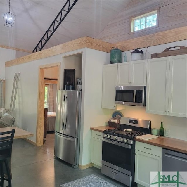26 Cason Dr, Pembroke, GA 31321 - kitchen featuring stainless steel appliances, wooden counters, concrete flooring, high vaulted ceiling, and baseboards