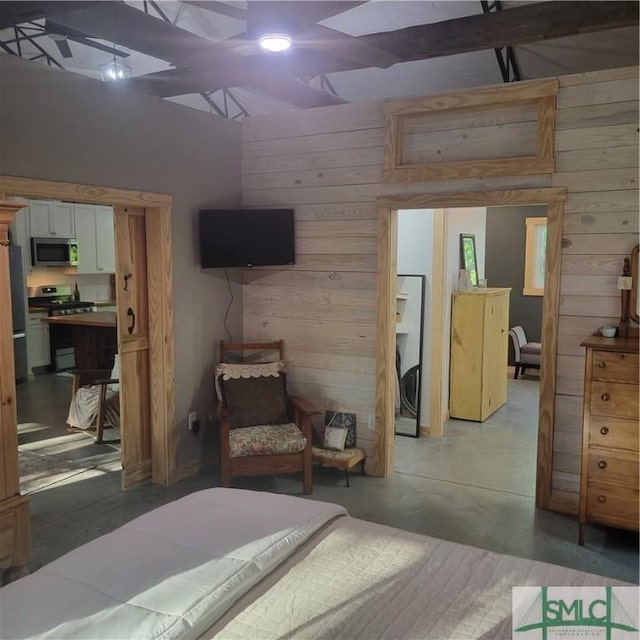 26 Cason Dr, Pembroke, GA 31321 - bedroom with wood walls, concrete flooring, and freestanding refrigerator