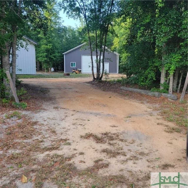 26 Cason Dr, Pembroke, GA 31321 - view of yard with an outdoor structure and a detached garage