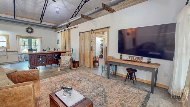 26 Cason Dr, Pembroke, GA 31321 - living room featuring a barn door and finished concrete flooring