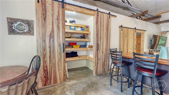 26 Cason Dr, Pembroke, GA 31321 - dining space with a barn door and concrete flooring
