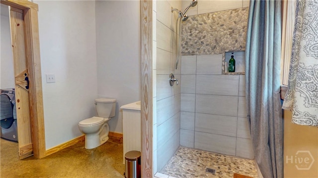 26 Cason Dr, Pembroke, GA 31321 - bathroom featuring a tile shower and washer / dryer