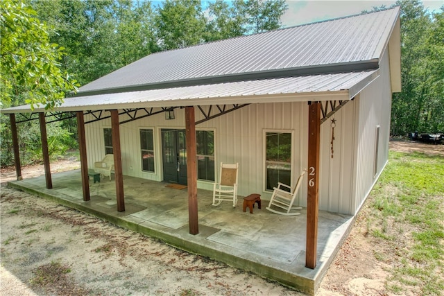 26 Cason Dr, Pembroke, GA 31321 - back of house with a patio and a metal roof