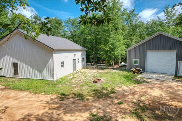 26 Cason Dr, Pembroke, GA 31321 - view of yard with a garage and an outdoor structure