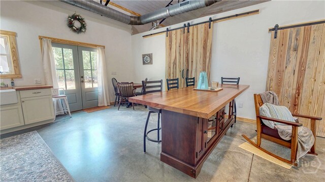 26 Cason Dr, Pembroke, GA 31321 - office space featuring a barn door, finished concrete flooring, french doors, and a high ceiling