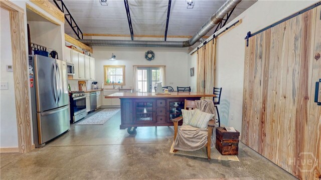 26 Cason Dr, Pembroke, GA 31321 - kitchen with stainless steel appliances, concrete floors, white cabinets, and light countertops