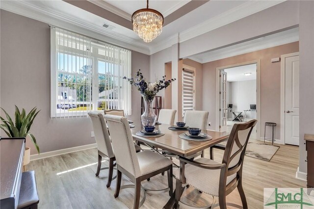 206 Park Chase Chase, Pooler, GA 31322 - dining area featuring light wood finished floors, ornamental molding, a chandelier, baseboards, and a raised ceiling