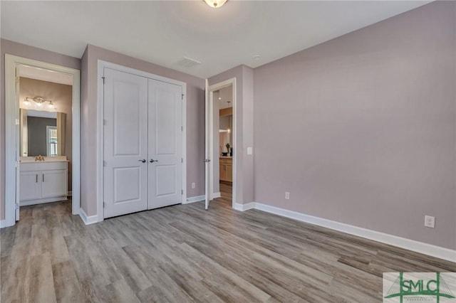 206 Park Chase Chase, Pooler, GA 31322 - unfurnished bedroom with wood finished floors, baseboards, a closet, and connected bathroom