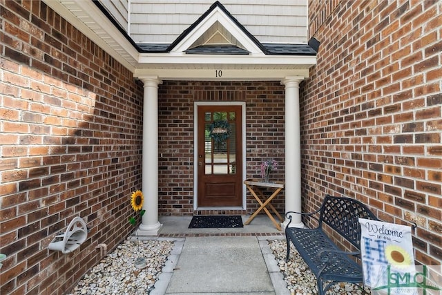 doorway to property with brick siding
