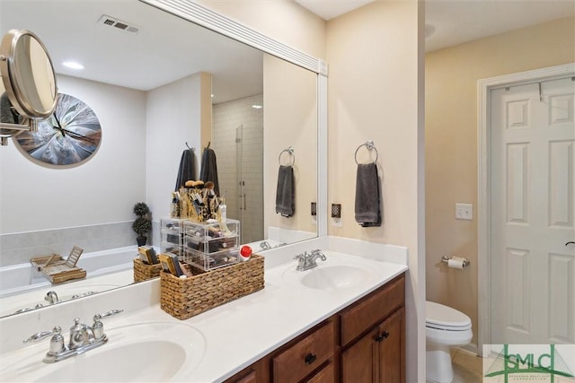 full bath featuring toilet, a stall shower, double vanity, and a garden tub
