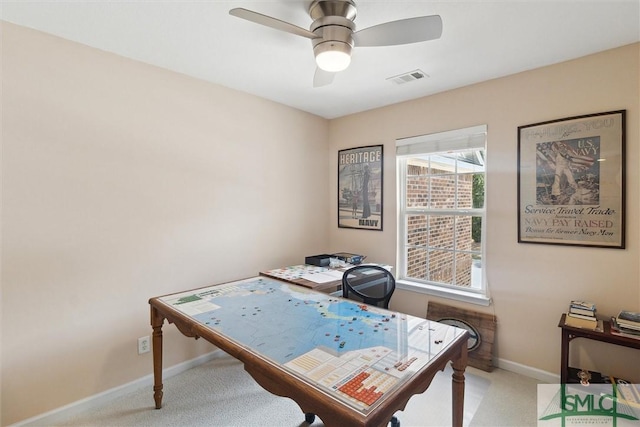 office space with light carpet, ceiling fan, and baseboards