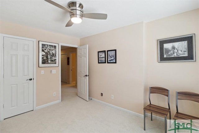 unfurnished room with light carpet, a ceiling fan, and baseboards