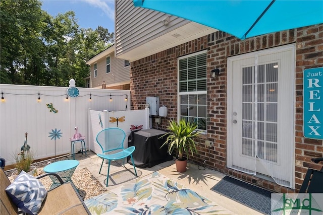 view of patio featuring fence