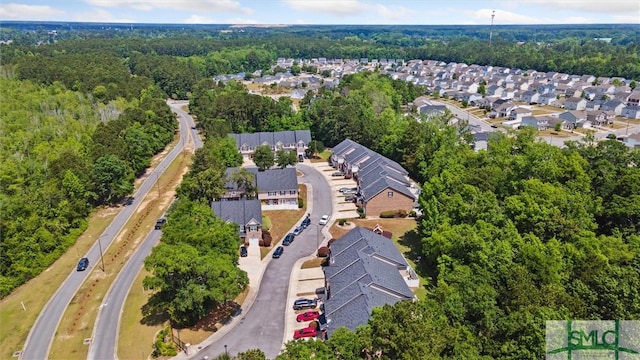 aerial overview of property's location with nearby suburban area and a heavily wooded area