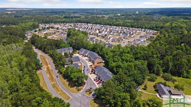 aerial overview of property's location featuring a heavily wooded area and nearby suburban area