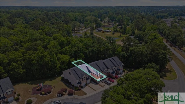 view of property location with a heavily wooded area
