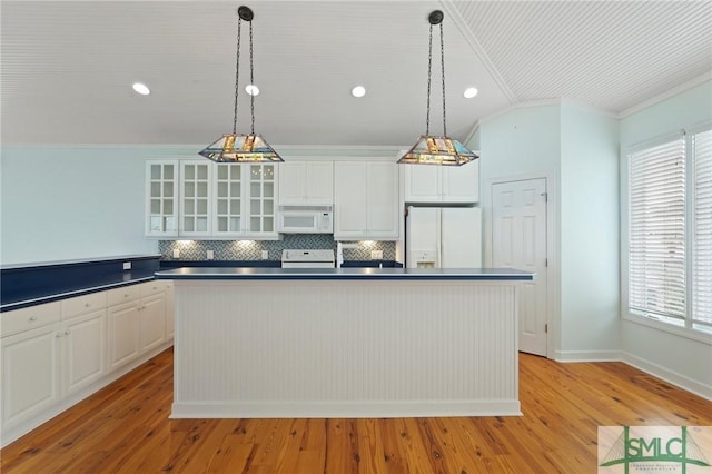 15 Teresa Ln, Tybee Island, GA 31328 - kitchen with white appliances, dark countertops, ornamental molding, plenty of natural light, and tasteful backsplash