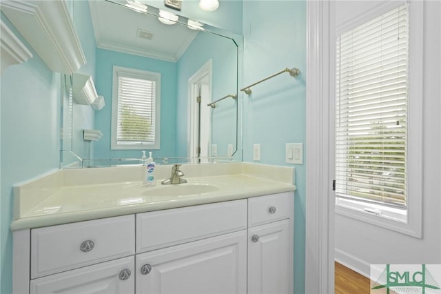 15 Teresa Ln, Tybee Island, GA 31328 - bathroom featuring ornamental molding, vanity, wood finished floors, and baseboards