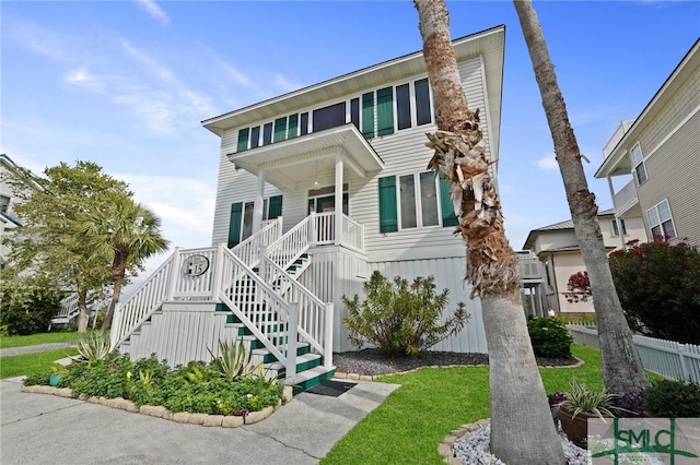 15 Teresa Ln, Tybee Island, GA 31328 - view of front of home featuring stairs, a front lawn, and a porch