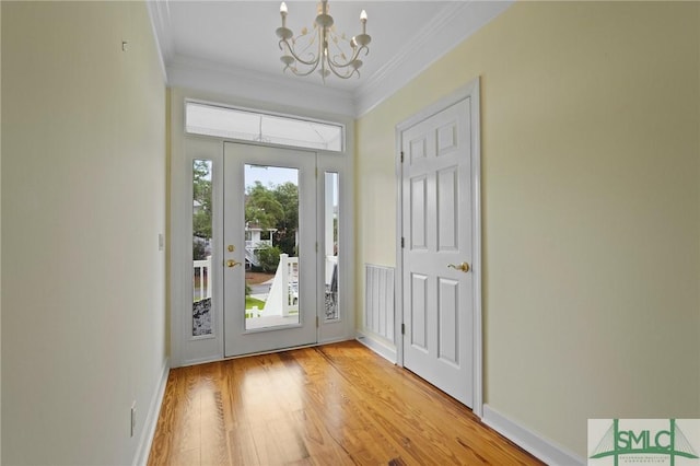 15 Teresa Ln, Tybee Island, GA 31328 - entrance foyer featuring a chandelier, crown molding, and light wood-style floors