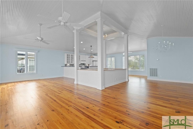 15 Teresa Ln, Tybee Island, GA 31328 - unfurnished living room with lofted ceiling, decorative columns, light wood-style floors, and a ceiling fan