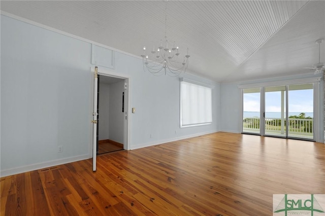 15 Teresa Ln, Tybee Island, GA 31328 - spare room featuring a chandelier, a ceiling fan, wood finished floors, and baseboards