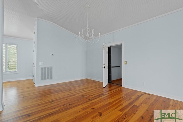 15 Teresa Ln, Tybee Island, GA 31328 - spare room with a chandelier, crown molding, hardwood / wood-style floors, baseboards, and lofted ceiling