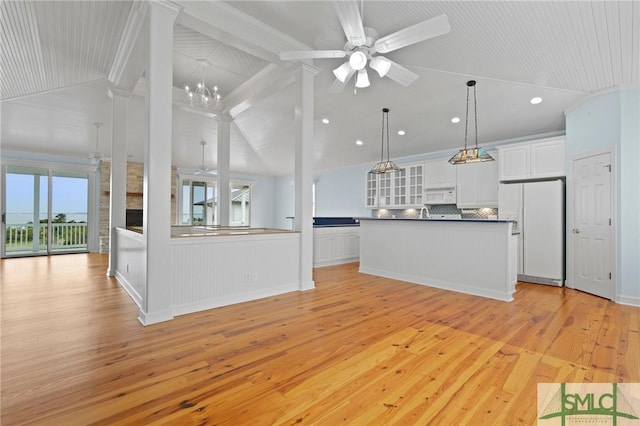 15 Teresa Ln, Tybee Island, GA 31328 - unfurnished living room featuring light wood-style flooring, ceiling fan, recessed lighting, ornate columns, and wainscoting