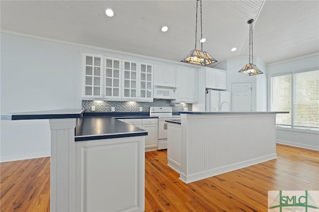 15 Teresa Ln, Tybee Island, GA 31328 - kitchen featuring white appliances, light wood-style floors, white cabinetry, recessed lighting, and ornamental molding