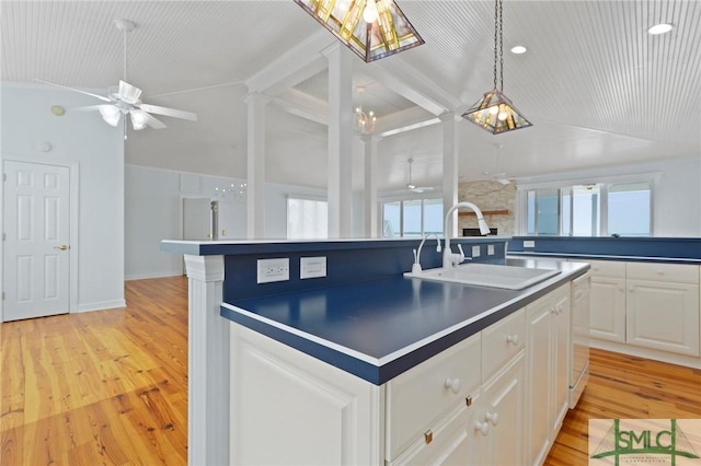 15 Teresa Ln, Tybee Island, GA 31328 - kitchen with lofted ceiling, a sink, a center island with sink, healthy amount of natural light, and a ceiling fan