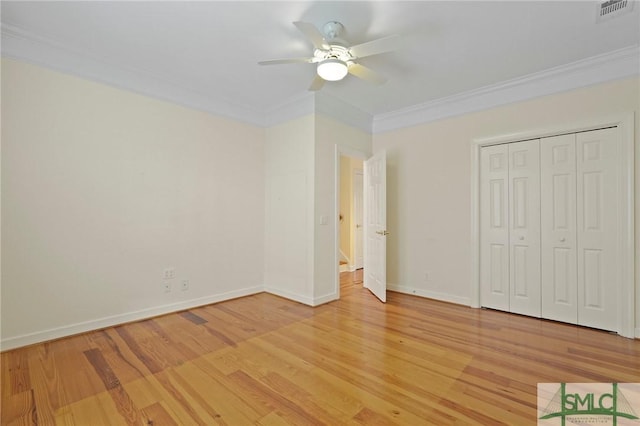 15 Teresa Ln, Tybee Island, GA 31328 - unfurnished bedroom featuring crown molding, light wood-style flooring, baseboards, a closet, and a ceiling fan
