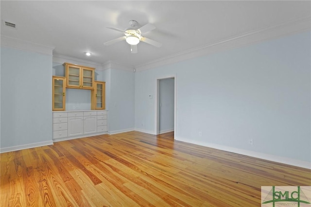 15 Teresa Ln, Tybee Island, GA 31328 - unfurnished room with crown molding, a ceiling fan, light wood finished floors, and baseboards